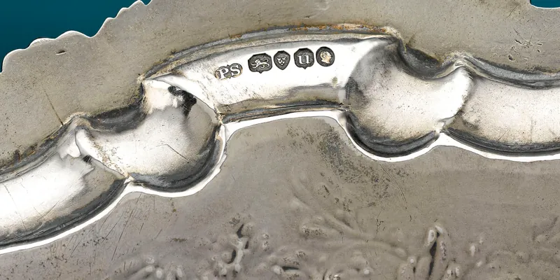 British silver hallmarks on a Paul Storr salver — a full row of stamps including maker's mark, lion passant, and assay office mark